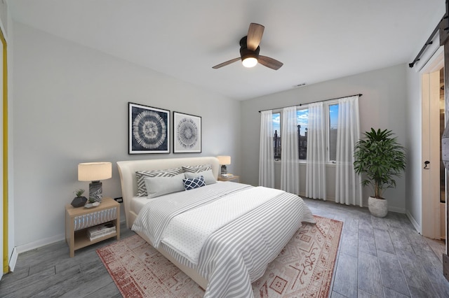 5200 N Rockwell St Unit 3N, Chicago, IL 60625 - bedroom featuring light wood-style flooring, a barn door, and ceiling fan