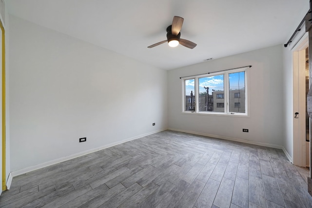 5200 N Rockwell St Unit 3N, Chicago, IL 60625 - unfurnished room with a ceiling fan, wood finished floors, and a barn door