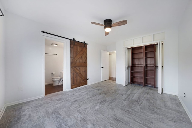 5200 N Rockwell St Unit 3N, Chicago, IL 60625 - unfurnished bedroom with a barn door, a closet, ensuite bath, and a ceiling fan