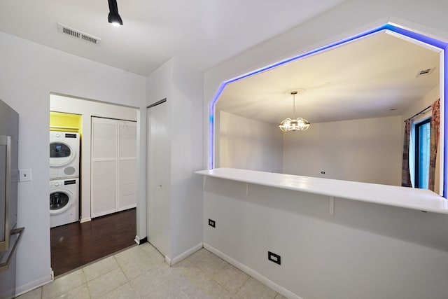 5200 N Rockwell St Unit 3N, Chicago, IL 60625 - interior space with stacked washer and clothes dryer, tile patterned floors, and a chandelier