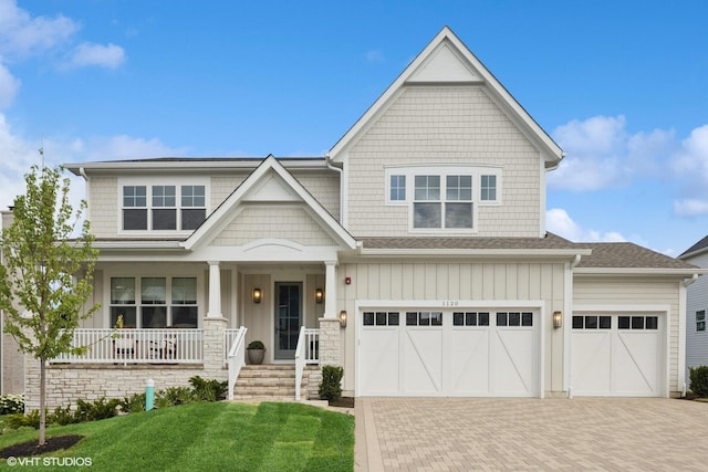 1120 Pin Oak Dr, Western Springs, IL 60558 - craftsman-style home featuring covered porch, decorative driveway, a front lawn, and a shingled roof