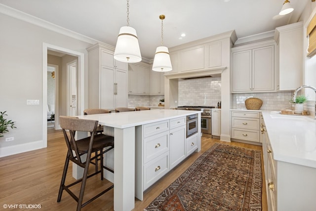 1120 Pin Oak Dr, Western Springs, IL 60558 - kitchen featuring a breakfast bar, a kitchen island, high end stainless steel range oven, backsplash, and crown molding