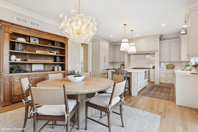 1120 Pin Oak Dr, Western Springs, IL 60558 - dining space featuring light wood-style flooring, a chandelier, ornamental molding, and recessed lighting