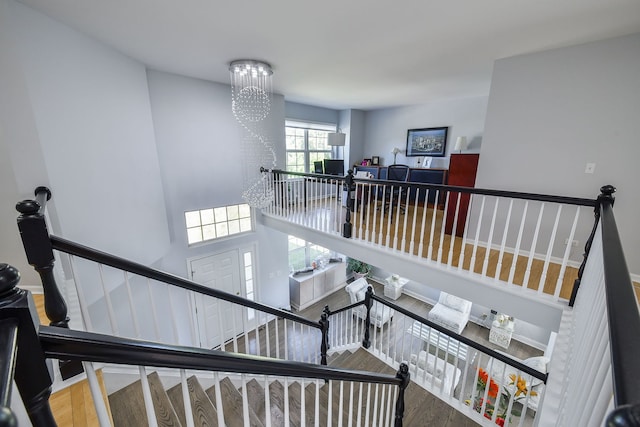 3142 Bennett Pl, Aurora, IL 60502 - stairway featuring wood finished floors and a chandelier