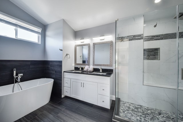3142 Bennett Pl, Aurora, IL 60502 - bathroom with tile walls, a shower stall, a freestanding bath, double vanity, and vaulted ceiling