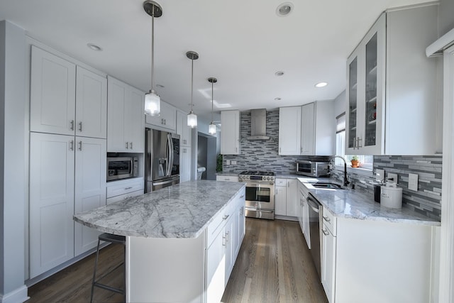 3142 Bennett Pl, Aurora, IL 60502 - kitchen with appliances with stainless steel finishes, wall chimney exhaust hood, decorative backsplash, a center island, and light stone countertops