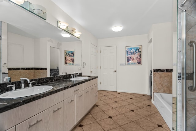 806 Lawler Ave, Wilmette, IL 60091 - full bathroom featuring double vanity, tile patterned flooring, a tub to relax in, washer / dryer, and a shower with door