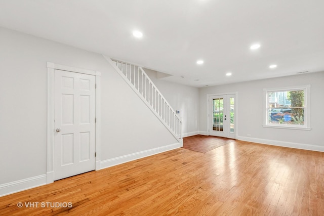 4721 S Woodlawn Ave Unit E, Chicago, IL 60615 - unfurnished living room with stairs, light wood-style flooring, recessed lighting, and french doors