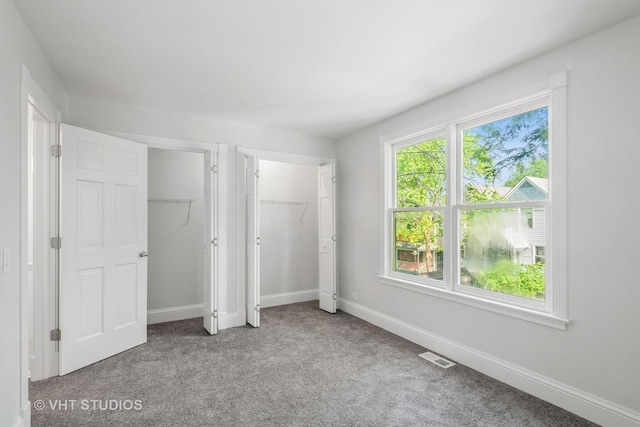 4721 S Woodlawn Ave Unit E, Chicago, IL 60615 - unfurnished bedroom featuring carpet and two closets