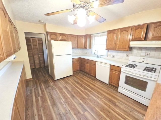 75 Bode Rd, Hoffman Estates, IL 60169 - kitchen featuring white appliances, under cabinet range hood, dark wood finished floors, brown cabinets, and light countertops
