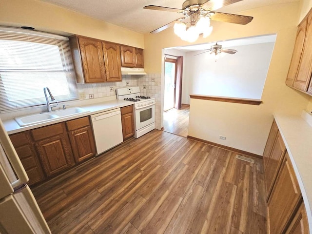 75 Bode Rd, Hoffman Estates, IL 60169 - kitchen with white appliances, under cabinet range hood, a ceiling fan, dark wood-type flooring, and light countertops