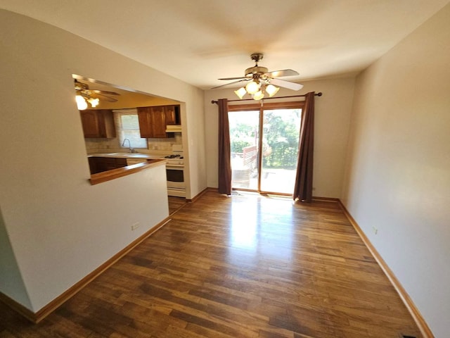 75 Bode Rd, Hoffman Estates, IL 60169 - unfurnished living room featuring ceiling fan, healthy amount of natural light, and dark wood-style flooring