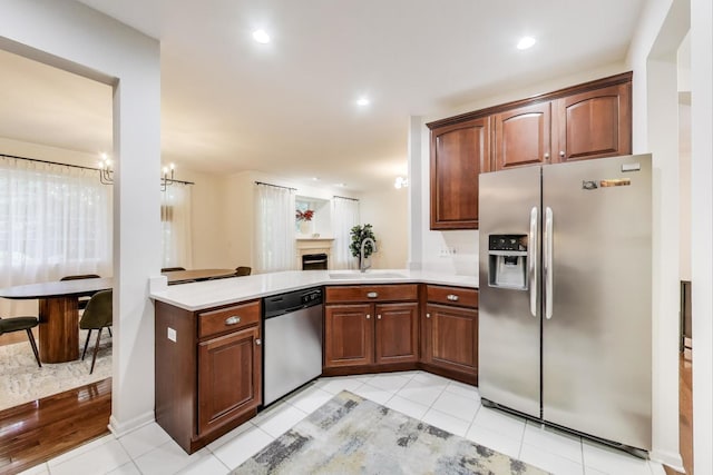 2302 Sandy Creek Dr, Algonquin, IL 60102 - kitchen featuring appliances with stainless steel finishes, light countertops, a peninsula, light tile patterned floors, and recessed lighting