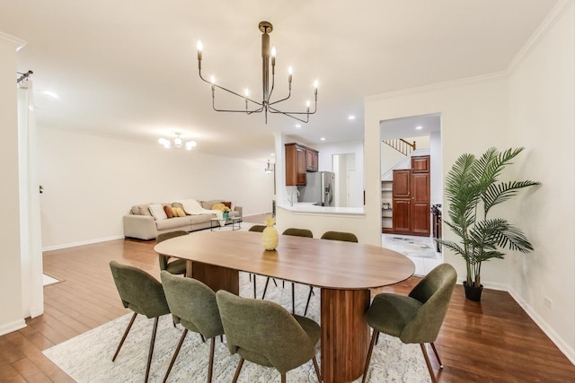 2302 Sandy Creek Dr, Algonquin, IL 60102 - dining room with a chandelier, wood finished floors, crown molding, recessed lighting, and stairway