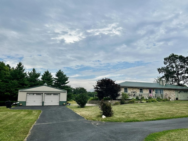 6119 Little Galilee Rd, Clinton, IL 61727 - view of front facade with a detached garage, an outdoor structure, a front lawn, and a metal roof