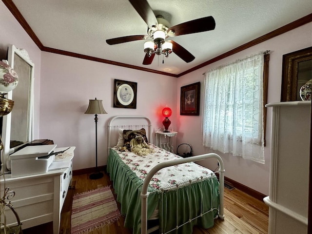 6119 Little Galilee Rd, Clinton, IL 61727 - bedroom with wood finished floors, crown molding, a textured ceiling, and a ceiling fan