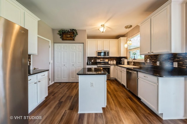 1550 W Ludington Cir, Romeoville, IL 60446 - kitchen featuring appliances with stainless steel finishes, decorative backsplash, dark countertops, and white cabinets