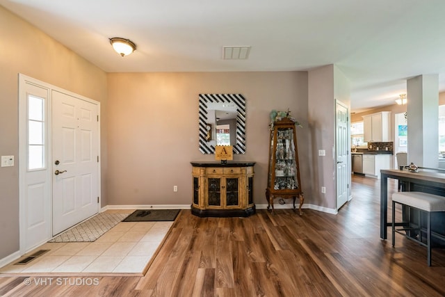 1550 W Ludington Cir, Romeoville, IL 60446 - entrance foyer featuring wood finished floors and healthy amount of natural light