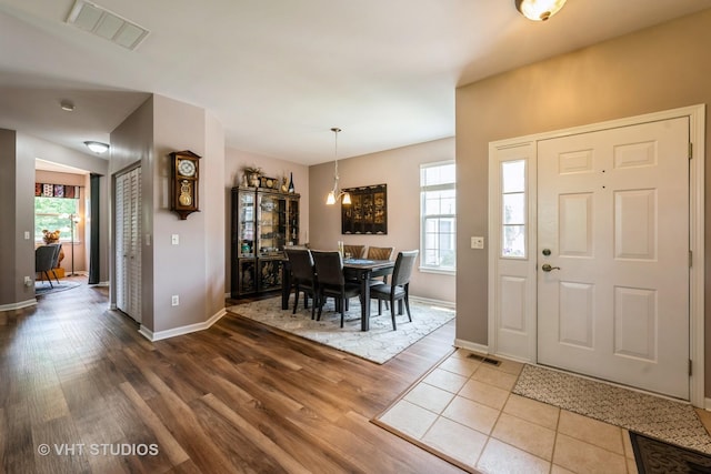 1550 W Ludington Cir, Romeoville, IL 60446 - dining space featuring wood finished floors and healthy amount of natural light