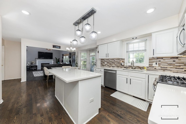 3730 Baybrook Dr, Aurora, IL 60504 - kitchen featuring dishwasher, decorative backsplash, white cabinets, a center island, and open floor plan
