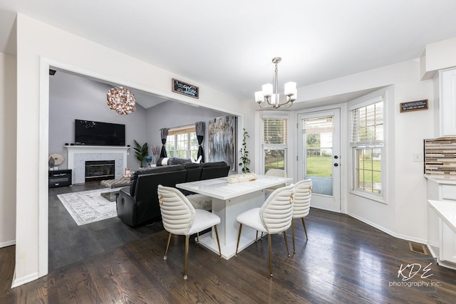 3730 Baybrook Dr, Aurora, IL 60504 - dining space with a chandelier, dark wood finished floors, and a glass covered fireplace
