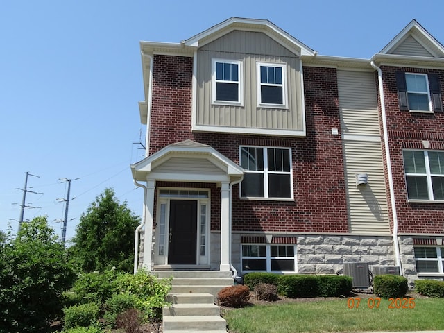 1108 Evergreen Ave, Des Plaines, IL 60016 - view of property featuring board and batten siding, brick siding, and entry steps