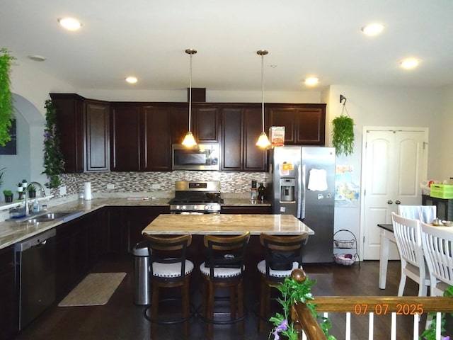 1108 Evergreen Ave, Des Plaines, IL 60016 - kitchen with appliances with stainless steel finishes, dark brown cabinets, light stone countertops, decorative backsplash, and recessed lighting