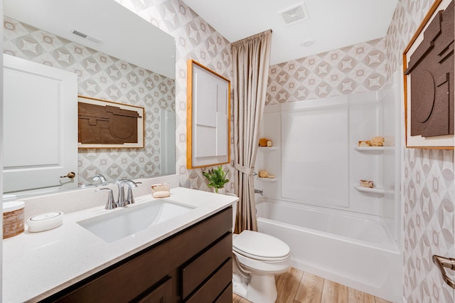 12124 Kelsey Dr, Huntley, IL 60142 - bathroom featuring wallpapered walls, vanity,  shower combination, and wood finished floors
