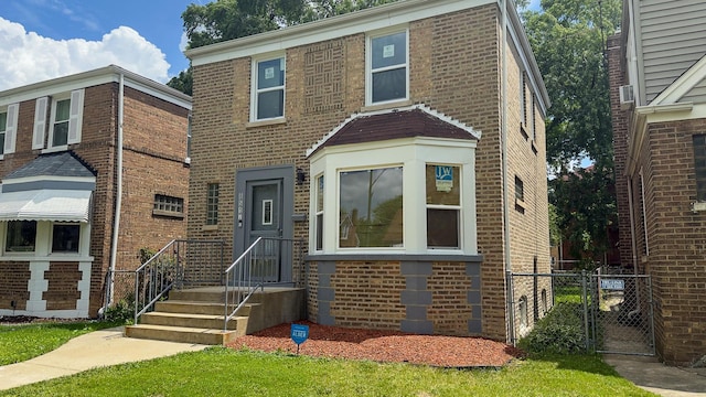 8517 S Wallace St, Chicago, IL 60620 - view of front of house featuring brick siding and a gate