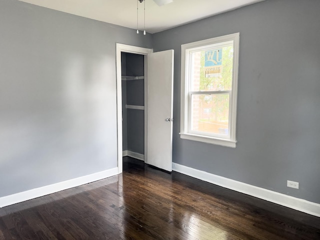 8517 S Wallace St, Chicago, IL 60620 - unfurnished bedroom featuring dark wood-style flooring and baseboards