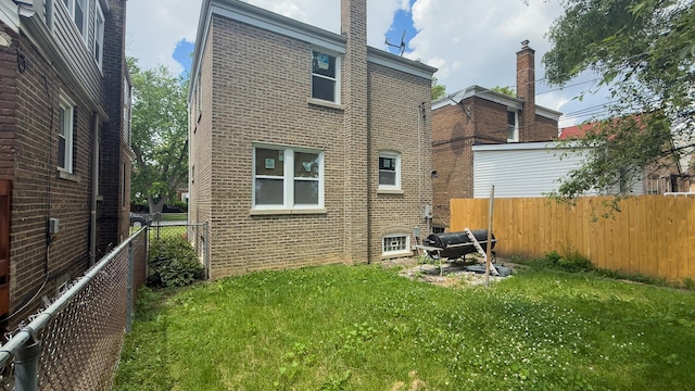 8517 S Wallace St, Chicago, IL 60620 - rear view of house with brick siding and a fenced backyard