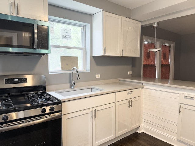 8517 S Wallace St, Chicago, IL 60620 - kitchen with stainless steel appliances, light countertops, white cabinets, dark wood-type flooring, and pendant lighting