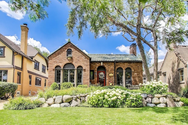 210 Berry Pkwy, Park Ridge, IL 60068 - back of house with a tile roof, brick siding, a chimney, and a yard