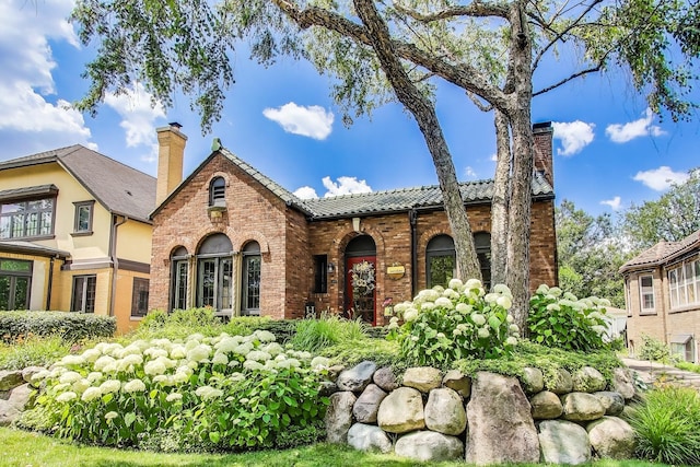 210 Berry Pkwy, Park Ridge, IL 60068 - view of front of house featuring a chimney, a tile roof, and brick siding