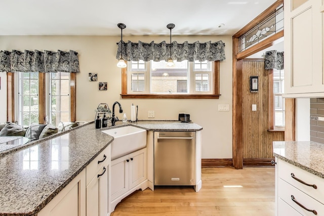210 Berry Pkwy, Park Ridge, IL 60068 - kitchen featuring stainless steel dishwasher, light wood-style flooring, plenty of natural light, and a peninsula