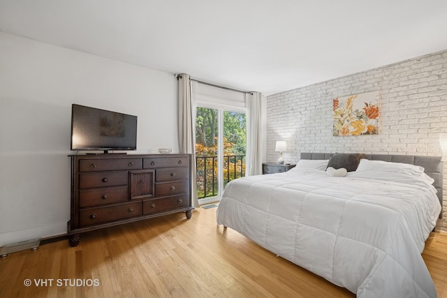 313 Hawthorn Ave Unit F, Glencoe, IL 60022 - bedroom featuring brick wall, wood finished floors, and access to outside
