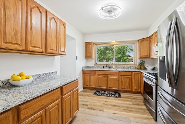 3551 Marseilles Ln, Hazel Crest, IL 60429 - kitchen with stainless steel appliances, light wood-style flooring, brown cabinetry, and light stone countertops
