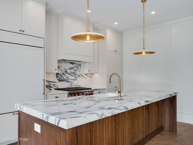 2832 N Racine Ave Unit 2W, Chicago, IL 60657 - kitchen with backsplash, light stone counters, white cabinets, decorative light fixtures, and recessed lighting