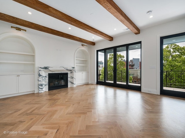 2832 N Racine Ave Unit 2W, Chicago, IL 60657 - unfurnished living room featuring built in features, plenty of natural light, a premium fireplace, beam ceiling, and recessed lighting