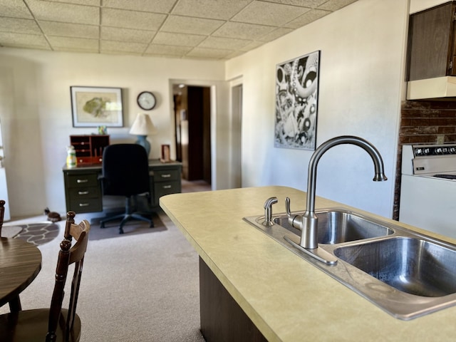 2503 Main St, Peru, IL 61354 - kitchen with range hood, carpet, a desk, dark brown cabinetry, and a drop ceiling