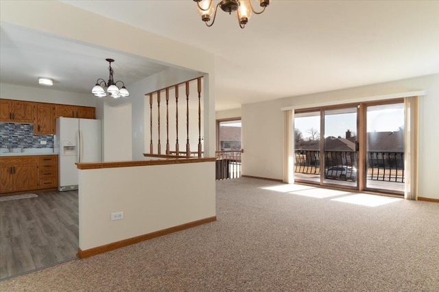 18014 Idaho Ct, Orland Park, IL 60462 - kitchen featuring a chandelier, white refrigerator with ice dispenser, brown cabinets, decorative light fixtures, and tasteful backsplash