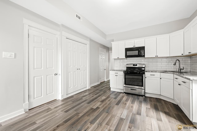 1336 Euclid Ave, Berwyn, IL 60402 - kitchen featuring stainless steel gas stove, black microwave, tasteful backsplash, and wood finished floors