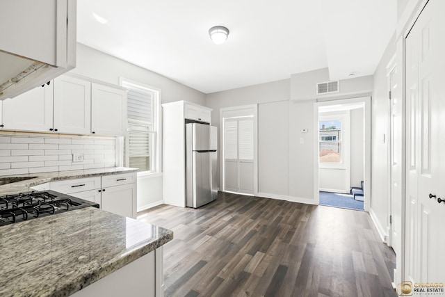 1336 Euclid Ave, Berwyn, IL 60402 - kitchen featuring freestanding refrigerator, decorative backsplash, light stone countertops, white cabinets, and dark wood-style floors