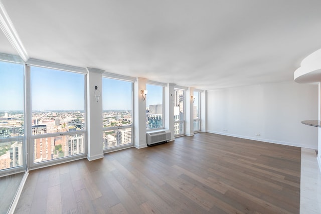 111 E Chestnut St Unit 55D, Chicago, IL 60611 - unfurnished living room featuring wood finished floors, plenty of natural light, and a wall of windows