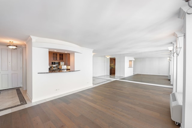 111 E Chestnut St Unit 55D, Chicago, IL 60611 - unfurnished living room featuring baseboards and wood finished floors