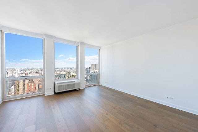 111 E Chestnut St Unit 55D, Chicago, IL 60611 - spare room with a city view, dark wood finished floors, and ornamental molding