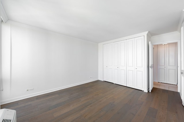 111 E Chestnut St Unit 55D, Chicago, IL 60611 - unfurnished bedroom featuring dark wood-style flooring, ornamental molding, and a closet