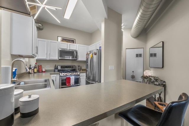 1418 W Cortez St Unit 4, Chicago, IL 60642 - kitchen with appliances with stainless steel finishes, a kitchen bar, a peninsula, and white cabinets