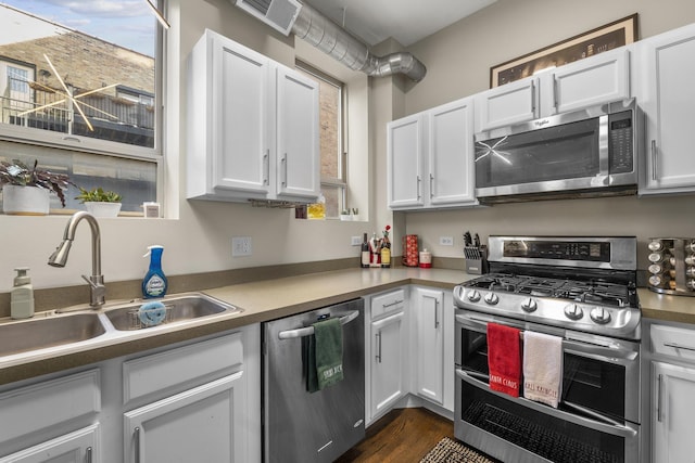 1418 W Cortez St Unit 4, Chicago, IL 60642 - kitchen featuring appliances with stainless steel finishes, white cabinets, and dark wood-style flooring
