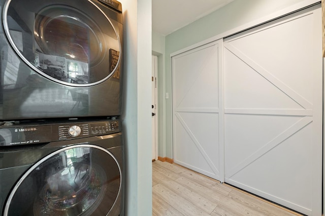 14515 Central Ct Unit Ph1, Oak Forest, IL 60452 - laundry room featuring stacked washing machine and dryer and light wood-type flooring